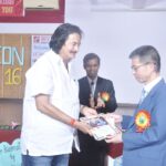 Prof. Sato receiving a gift as the token of their appreciation 